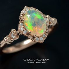 an opal and diamond ring on a black background