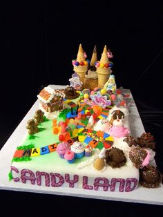 a birthday cake with ice cream and candy land on it