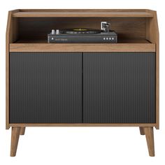 the sideboard has a record player on it and is made out of wood with two doors