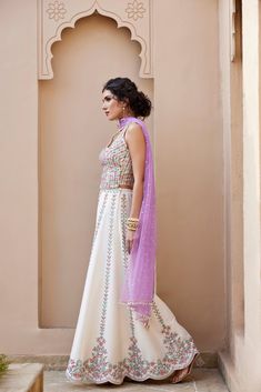 Mirror and Colorful resham Embroidered Ivory dupion silk top and flared pant Paired with contrast lavender Tulle dupatta with pearl embroidery detailing .From Chamee and Palak's The Romantics collection.DELIVERY TIMEPlease allow 8-12 weeks for your outfit to arrive.FABRIC DETAILSDupion SilkProfessional cleaning only. Off White Raw Silk Designer Wear Sets, Off White Raw Silk Sets For Designer Wear, Off White Raw Silk Designer Sets, Off White Silk Anarkali Set With Dupatta, Raw Silk Off-white Sets For Festivals, Off White Raw Silk Sets With Traditional Drape, Off White Silk Anarkali Set, Bollywood Style Off White Raw Silk Set, Off White Raw Silk Set For Festivals