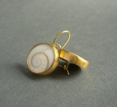 "Timeless and stylish, these pretty earrings are beautiful for daytime as well as evening wear. In their simplicity, these earrings make a sculptural, contemporary statement. A pair of slightly domed operculum shells are bezel set in a combination of 22-karat gold and 18-karat gold. The gold has a matte/brushed finish. These hand made earrings measure about 1/2\" in diameter and 7/8\" from top of the ear wire to the bottom of the earrings. In millimeters, the earrings measure about 13 mm in diam Handmade Elegant Spiral Earrings, Elegant Handmade Spiral Earrings, Elegant Handmade Swirl Earrings, Spiral Single Earring Gift, Spiral Single Earring As Gift, Handmade Spiral Yellow Gold Jewelry, Elegant Hand Forged Swirl Earrings, Elegant Swirl Shaped Hand Forged Earrings, Gold Spiral Earrings As Gift