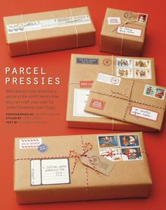 four wrapped packages with stamps on them sitting on an orange surface