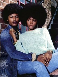 two people sitting next to each other in front of a brick wall with the caption's name on it