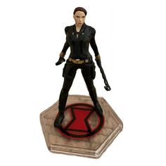 an action figure standing on top of a round object