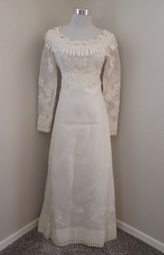 Beautiful early 70s, could be late 60s wedding dress. Sheer white organza with lovely flower chain lace trim on the empire waist, sleeves, cuffs and hemline. Back zipper. Lined. Sheer sleeves. Excellent vintage condition. Label: none Material: organza Color: white Size: XS/S- see measurements below for size guidance Dimensions: taken laying flat with armpit to armpit NOT doubled. The rest are doubled. ALL MEASUREMENTS ARE APPROXIMATE, purses too! Armpit to armpit: 16.5" side to side Waist: 25" Shoulders: 13.5" Sleeves:  23" Hips: 38" Length:  52" I do not launder or dry clean them to keep the cost down. Some items may have an odor due to age, perfume, etc... ESPECIALLY PURSES! If you have allergies, please be advised that you may have to launder immediately. This does not mean that all my Retro Vintage Wedding Dress With Lace Trim, Vintage Fitted Dress With Sheer Sleeves, Long Sleeve Lace Vintage Wedding Dress, Fitted White Vintage Dress With Lace Collar, Fitted Vintage White Dress With Lace Sleeves, Vintage Lace Dress With Sheer Sleeves, Fitted White Vintage Dress With Lace Sleeves, Vintage Lace Dresses With Sheer Sleeves, Vintage Style White Dresses With Lace Trim