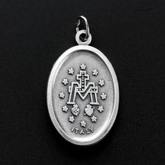 Traditional Miraculous Mary medal. This silver oxidized medal has gorgeous details and would be a lovely addition to your next rosary or jewelry project. It is imported from Italy and ready to be used in your next jewelry design. The Miraculous Medal is one of the most popular Catholic medals. It was created by St. Catherine Laboure following a vision of the Blessed Virgin Mary in 1830. This medal is believed to bring special intercessions on behalf of the Blessed Virgin Mary if worn with faith St Catherine Laboure, Catherine Laboure, The Immaculate Conception, The Blessed Virgin Mary, Immaculate Conception, Catholic Medals, St Catherine, Blessed Virgin, Blessed Virgin Mary