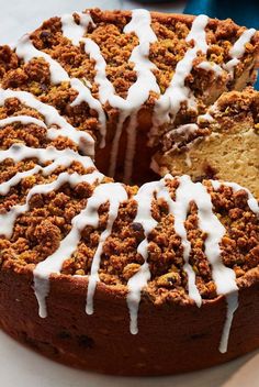 a cake with white icing on it sitting on a plate