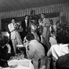 a group of people that are sitting around a table with musical instruments in front of them