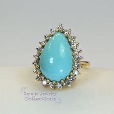 Pretty Levian Sleeping Beauty Turquoise diamond ring, This cabochon is cut in a cute teardrop shape and has a halo of round brilliant diamonds.Ring Size: 7Total Weight: 8.31 gramsPrecious Metal: 14k yellow goldPrecious stones:-Sleeping Beauty Turquoise Center Stone: 17mmx11.5mm, 13.8 carats-White Round Diamonds: 0.63 caratsHallmark: Levian, 14k Formal Turquoise Diamond Ring With Gemstone, Formal Turquoise Diamond Ring, Formal Fine Jewelry Turquoise Diamond Ring, Elegant Turquoise Cabochon Diamond Ring, Oval Diamond Turquoise Ring For Formal Occasions, Formal Oval Turquoise Ring With Diamond, Gift Diamond Turquoise Cabochon Ring, Elegant Turquoise Ring With Halo Setting For Anniversary, Blue Diamond Turquoise Ring With Cabochon