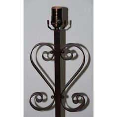 a metal candle holder with a heart shaped design on the front and back of it