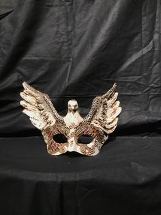 Eagle Mask. Traditional and original papier-mache Venetian mask, handmade and decorated with acrylics colors,stuggles,glitter and wax. The mask has double paper mache. All our masks are handmade papier-machè masks made in Venice. Our decorators use techniques typical of the Venetian tradition such as stucco, acrylics, gold and silver-leaf, macramè, passementerie, pearls and crequelè to give you a wide range of masks This shape is available in many different designs, colors and techniques. Ask us Traditional Masquerade Mask For Carnival Festivals, Traditional Masks For Mardi Gras Carnival, Traditional Masks And Prosthetics For Carnival, Traditional Masks And Prosthetics For Mardi Gras Carnival, Traditional Mardi Gras Mask, Traditional Mardi Gras Masquerade Mask, Traditional Eye Mask For Costumes, Artistic White Masks For Festivals, Traditional White Masks For Masquerade