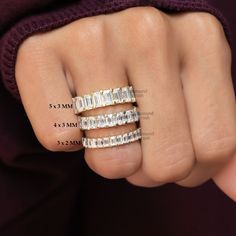 a woman's hand with three rings on it and measurements for the ring size