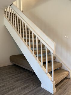 an empty room with stairs and carpeted flooring