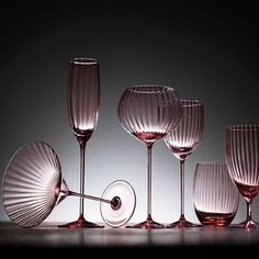 several wine glasses are lined up on a table