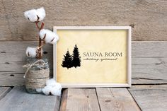 there is cotton in a glass vase next to a sign that says sauna room