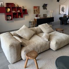 a living room filled with furniture and lots of bookshelves on top of it