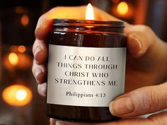 someone holding a candle in their hand with the words i can do all things through christ who straightens me