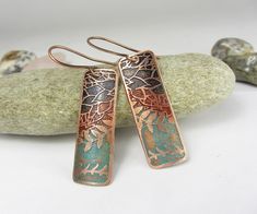 I produce designs by hand or digitally and transfer these onto metal using modern etching techniques.The metal has been patinated and partly polished to enhance the natural texture. Unique copper earrings with colorful Wax Patina. Each piece is sealed with a lacquer.  Total length including ear wires is approx 2.1  x  0.5inches or     5.4 x 1.2 cm.  All jewelry is handcrafted in my home studio. Item ships free registered mail. All my items are safely and nicely packed in solid gift boxes, ready for gift giving! Enter my shop here: https://www.etsy.com/shop/DrahomiraJewelry Patterned earrings: https://www.etsy.com/shop/DrahomiraJewelry?ref=seller-platform-mcnav&section_id=22354425 Patterned pendant: https://www.etsy.com/shop/DrahomiraJewelry?ref=seller-platform-mcnav&section_id=22342628 Ham Artistic Etched Earrings As A Gift, Etched Copper Jewelry, Etching Techniques, Jewelry Journal, Copper Earrings Handmade, Copper Anniversary Gifts, Copper Anniversary, Copper Jewelry Handmade, Etched Copper