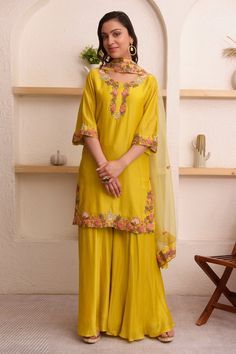 Mustard yellow kurta with thread, floral embroidery on placket and sleeve hem. Paired with sharara and dupatta.
Component: 3
Pattern: Embroidery
Type Of Work: Thread, floral
Neckline: Round
Sleeve Type: Three quarter
Fabric: Chanderi, organza
Color: Yellow
Other Details: 
Scallop bordered sheer dupatta
Occasion: Mehendi and Haldi - Aza Fashions Sheer Dupatta, Yellow Kurta, Kurta Sharara Set, Kurta Sharara, Chanderi Kurta, Sharara Set, Pattern Embroidery, Set For Women, Embroidery Thread