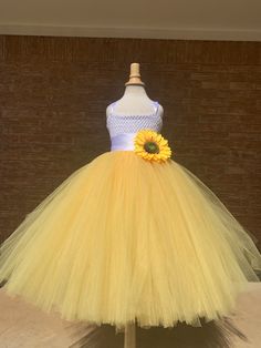 a yellow and white dress with a sunflower on it