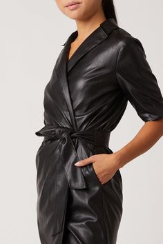 Our Robin Vegan Leather Dress, is a sultry trench dress that signifies everything chic. This bold black mini has 3/4 length sleeve detail, is made of our Vegan Leather with Japanese Technology, and hits above the knee in length. 100% Vegan Leather - 100% Polyurethane Dry Clean Only Made in USA Model is 5'11 and wearing size S Belted Mini Dress With Short Sleeves For Work, Belted Short Sleeve Mini Dress For Work, Fall Workwear Belted Mini Dress, Fall Night Out Belted Blazer Dress, Belted Blazer Dress For Fall Night Out, Formal Short Sleeve Mini Dress With Belt, Formal Short Sleeve Belted Mini Dress, Sleek Black Blazer Dress For Office, Sleek Black Office Blazer Dress