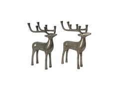 two metal deer statues sitting next to each other