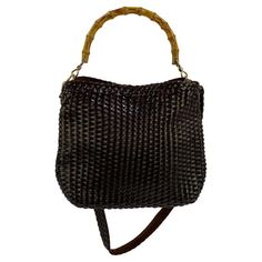 TheRealList presents: an intricately woven leather Gucci bag, designed by Tom Ford. This bag is constructed entirely of brown woven leather and is completed with a natural bamboo handle and matching woven shoulder strap. The gold-colored hardware perfectly completes this well-crafted, iconic Gucci bag. This bag was created as part of the S/S 1997 collection and was prominently featured in the collection's look book/catalog. This timeless design created by Tom Ford is the perfect addition to any Gucci By Tom Ford, Crocodile Handbags, Tom Ford Bag, Bamboo Bag, Leather Hobo, Bag Straps, Fashion Handbags, Tom Ford, Gucci Bag