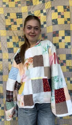 a girl standing in front of a quilted wall with her hands on her hips