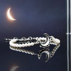 Catch a wave of gorgeousness with this Lunar Tide Pearl Bracelet! Made from pearls and set on a delicate chain of Platinum, this gorgeous accessory is sure to make you look out of this world! Add a hint of sparkle to any outfit and make a fashionable statement--the waves won't be able to resist! DETAILS Materials:   Platinum on Brass, Mother of Pearl Beads, Zircon Measurements: Length:  7.09 "(18cm)  + Extender: 1.18"(3cm) Weight:  6.9 g Elegant Moon Charm Bracelet, Elegant Adjustable Crescent Bracelet, Elegant Adjustable Bracelet With Moon Charm, Elegant Silver Bracelets With Moon Phase, Elegant Adjustable Crescent Jewelry, Elegant Silver Moon Phase Bracelet, Elegant Adjustable Crescent Shaped Jewelry, Elegant Moon Phase Bracelet As A Gift, Elegant Moon Phase Bracelets