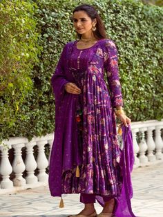 This Set Has a Anarkali, bottom and dupatta. Floral printed tier Anarkali set with hand embroided yoke. It is paired with matching chanderi foil print dupatta enhanced with fabric detailing and palazzo pants. Color: Purple Fabric: Anarkali - Cotton Silk Bottom - Shantoon Dupatta - Chanderi Product Details: Neck Type - Round neck Anarkali Length - 50 inches Bottom Length - 38-40 inches Sleeve Length - 22 inches Note: Available in other colors The product will be delivered within 2-4 weeks of orde Festive Printed Motifs Anarkali Set For Diwali, Festive Anarkali Set With Printed Motifs For Diwali, Diwali Maxi Length Sets With Printed Motifs, Diwali Maxi Sets With Printed Motifs, Festive Anarkali Palazzo Set With Printed Motifs, Anarkali Palazzo Set With Printed Motifs For Festive Occasions, Transitional Festive Anarkali Set With Printed Motifs, Anarkali Style Festive Palazzo Set With Printed Motifs, Diwali Printed Motifs Maxi Length Sets