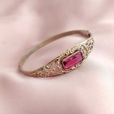 "Beautiful looking vintage hinged bracelet with a filigree goldplate design on a silver base. Bangle is adorned with a gorgeous and shiny faceted ruby red glass center stone in a bezel setting. The bracelet is weighing 12 grams [0,4 oz], the opening measures 6 cm [2,3\"] in diameter, with the circumference of 18 cm [7\"] , and width of 16 mm [0,7\"] at the widest place. Bracelet is stamped with crown over letter B. In excellent vintage condition, with a fully functional box clasp. Our other brac Chunky Gold Bracelet, Boho Bangle, Simple Bangle, Brass Bangle, Teardrop Dangle Earrings, Box Clasp, Vintage Bracelet, Hinged Bracelet, Filigree Design