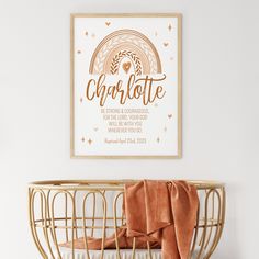 a baby crib with an orange blanket on it and a poster above the crib