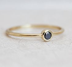 Pretty little ring. A solitaire black diamond ring. ★Details Gemstone: black diamond Measurements: approx. 3 mm Band width: approx. 1.2 mm Material: 14/18k solid yellow/white/rose gold, platinum Sizes available: 2-8 (Larger and smaller sizes are available as well. Priced upon request.) The price listed is for one ring only. We use natural, untreated black diamonds. Natural black diamonds can have imperfections in them like spots or small veins. We can provide treated diamonds that do not have th Black Diamond Solitaire Ring, Black Diamond Bands, Black Diamond Solitaire, Diamond Solitaire Ring, Black Diamond Ring, Ring Simple, Black Diamonds, Green Sapphire, Agate Ring