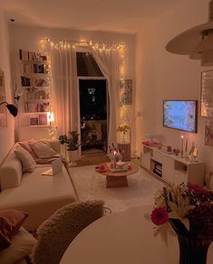 a living room filled with furniture and a flat screen tv sitting on top of a wall