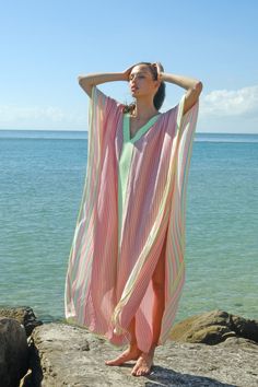 A spinoff on one of our fan favorites, the Thobe, this Contrast Striped Thobe features a delicate hand-loomed fabric in a light and breezy silhouette, with a V-neckline and an elegant contrasting striped pattern throughout the bodice. Striped Kaftan For Summer Beach Cover-up, Pink V-neck Kaftan For Summer, Striped Kaftan For Spring Vacation, Spring Striped Kaftan For Beach Cover-up, Bohemian Striped Kaftan For Summer, Striped Kaftan For Summer Vacation, Pink V-neck Kaftan For Spring, Summer V-neck Kaftan For Daywear, Boho Beachy