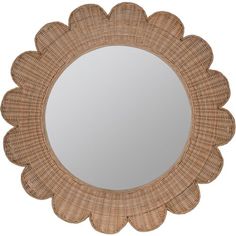 a round wicker mirror with a flower design on the front and bottom part of it