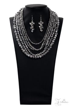 Dipped in half in a metallic shimmer, a scintillating collision of a faceted hematite and crystal-like beading drape across the chest for a spellbinding look. Held together by two silver fittings, the blinding strands gradually increase in size as they trickle down the chest fearless finish. Features an adjustable clasp closure. Sold as one individual necklace. Includes one pair of matching earrings 7/30/19