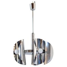 a large chrome chandelier with two circular lights hanging from it's sides