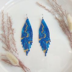 Exquisite and charming, these long beaded earrings feature a sophisticated blue marble design. Handcrafted with meticulous attention to detail, they exude a timeless elegance. Perfect for adding a touch of refinement to any ensemble, these earrings are sure to become a cherished addition to your jewelry collection. Dimensions: - Length: 10 cm (3.9 inches) - Width: 3 cm (1.2 inches) Bohemian Blue Long Drop Beaded Earrings, Elegant Blue Tassel Earrings As Gift, Elegant Blue Tassel Earrings For Gift, Blue Beaded Tassel Dangle Earrings, Elegant Long Drop Beaded Tassel Earrings, Elegant Blue Tassel Earrings, Elegant Light Blue Beaded Chain Jewelry, Elegant Light Blue Beaded Jewelry, Blue Beaded Tassel Drop Earrings