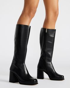 Crafted for ultimate sophistication, these knee-high boots boast a sleek square toe and sturdy block heel for effortless style. Elevate your wardrobe with the MYSTERY platform boot. 3.25 inch heel height 1 inch platform Size 6 measurements: 14 inch shaft circumference, 14.25 inch shaft height Size 8 measurements: 15.5 inch shaft circumference, 15 inch shaft height Size 10 measurements: 16 inch shaft circumference, 15.5 inch shaft height Leather upper material Textile and synthetic lining Synthet Tall Platform Boots With Stacked Heel, Black Tall Platform Boots With Wide Calf, Black Tall Wide Calf Platform Boots, Square Toe Platform Boots For Work, Trendy Wide Calf Platform Boots With Block Heel, Workwear Platform Boots With Square Toe, Faux Leather Knee-high Boots With Platform And Block Heel, Knee-high Faux Leather Platform Boots With Stacked Heel, Trendy Knee-high Boots With Chunky Platform And Block Heel