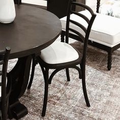 a black table with white chairs around it