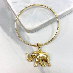 "18k Gold Filled Charms Elephant Bracelet The elephant is generally considered a symbol of good luck and the animal is a symbol of good fortune. Elephant jewelry is commonly believed to bring luck to the person who is wearing it and makes a great gift for wishing someone luck with something. - Bracelet Size: Thickness: 2mm | Charm Width: 35.3mm Charm Thickness: 7.9mm | Charm Height: 1.4 inches 💎 With new products daily, quality and competitive prices, in DiJu Jewelry you find the most unique st Gold Charm Bangle Bracelet, Gold Hoop Cuff Bracelet As Gift, Gold Hoop Cuff Bracelet Gift, 3d Elephant, Elephant Jewelry, Elephant Bracelet, Elephant Charm, Protection Bracelet, Bangle Bracelets With Charms