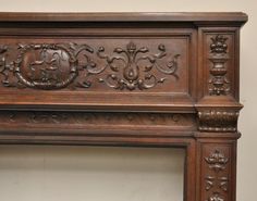 an ornate wooden fireplace mantel with carvings