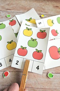 four apples and two oranges are on the matching cards for numbers 1 - 10