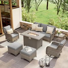 an outdoor patio with furniture and fire pit