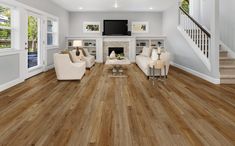 a living room with hardwood floors and white furniture