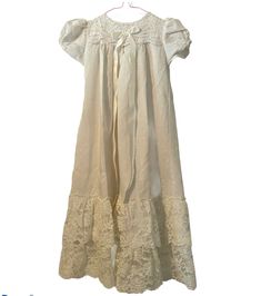 Vintage Something Pretty Baby White Ruffled Lace Dress Cradle Club Made in USA S. Shipped with USPS First Class. Adorable king baby dress with lace layers on hem and sleeves. Long ribbon and bow with light Diamond pattern throughout and buttons. It is vintage so it’s not perfect, but I do not see any major flaws Fitted Cotton Baptism Dress With Ruffles, Fitted Short Sleeve Baptism Dress With Ruffles, Fitted Summer Baptism Dress With Ruffles, White Ruffled Retro Vintage Dress, Lace Baptism Dress With Ruffles And Short Sleeves, White Retro Vintage Dress With Ruffles, Vintage Dress With Lace Trim For Baptism, Vintage Summer Dresses For Baptism, Vintage White Cotton Dress With Ruffles