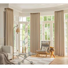 a living room filled with furniture and windows covered in beige drapes, along with a checkered rug on the floor