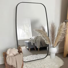 a large mirror sitting on top of a white rug