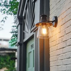 a light that is on the side of a building next to a door and window